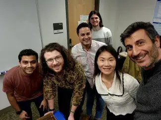 Several students standing next to Dr. Silvestri